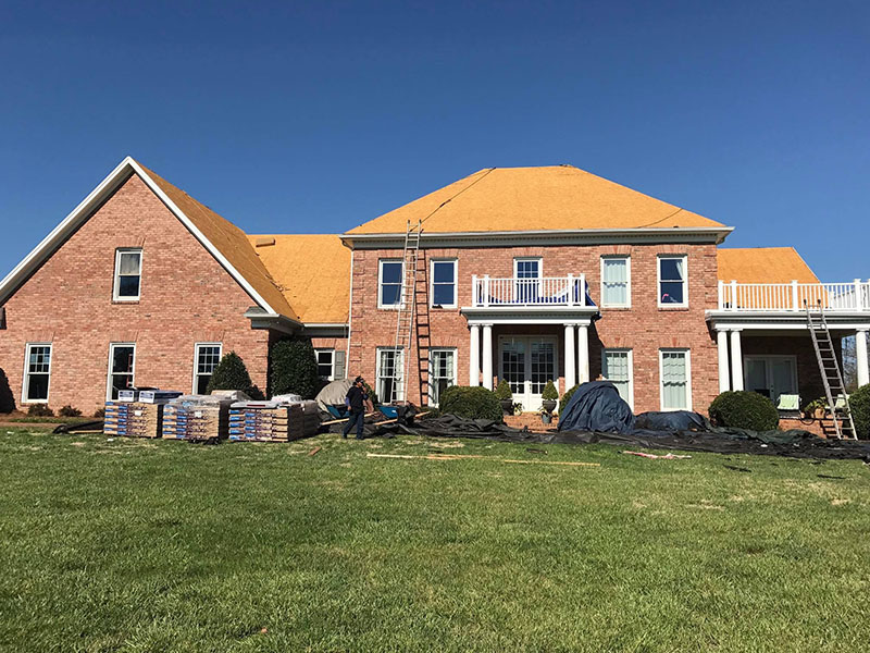 A house receiving help from a roofing contractor in Monroe, NC